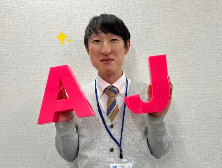 AJを持ったスタッフの画像